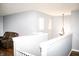 Upstairs hallway with neutral paint, dark floors, and an updated light fixture at 1242 Flatrock Dr, Anderson, IN 46013