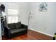 Bright living room area featuring a modern couch, updated flooring, and natural lighting at 1242 Flatrock Dr, Anderson, IN 46013