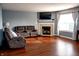 Cozy living room features a fireplace, large window with natural light, and laminate flooring at 1242 Flatrock Dr, Anderson, IN 46013