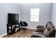Cozy living room with a media center, leather recliner, and updated flooring at 1242 Flatrock Dr, Anderson, IN 46013