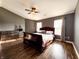 Spacious main bedroom with dark wood floors, stylish furniture, and lots of natural light at 1242 Flatrock Dr, Anderson, IN 46013