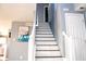 Staircase leads to the upper level, featuring fresh white trim and gray walls at 1242 Flatrock Dr, Anderson, IN 46013