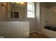 A bathroom with a double sink vanity, mirror and a tub with white subway tile at 12524 Morning Ridge Way, Noblesville, IN 46060