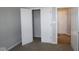 This is a bedroom with light gray walls and a closet with white doors and tan carpet at 12524 Morning Ridge Way, Noblesville, IN 46060