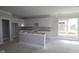 Spacious kitchen under construction featuring white cabinets and a center island, ready for customization at 12524 Morning Ridge Way, Noblesville, IN 46060