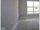 This is a room with light gray walls, white trim and bare concrete floors and large windows at 12524 Morning Ridge Way, Noblesville, IN 46060