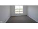 Bedroom showcasing natural light through a large window, neutral carpet, and fresh paint at 12532 Morning Ridge Way, Noblesville, IN 46060