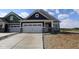 New construction home featuring a two-car garage, stone accents, and a modern, stylish design at 12532 Morning Ridge Way, Noblesville, IN 46060