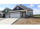 New construction home featuring a two-car garage, stone accents, and a modern, stylish design at 12532 Morning Ridge Way, Noblesville, IN 46060