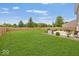 Spacious backyard with well-manicured lawn and a built-in grill area perfect for outdoor entertaining and relaxation at 12845 Touchdown Dr, Fishers, IN 46037