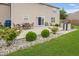 Beautiful backyard featuring a patio set, stone grill, lush lawn, and manicured landscaping at 12845 Touchdown Dr, Fishers, IN 46037