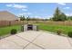 Spacious backyard features a concrete patio with an outdoor kitchen area, surrounded by a well-kept lawn and fence at 12845 Touchdown Dr, Fishers, IN 46037