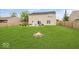 Large, well-maintained backyard featuring a stone fire pit, patio, and green grass perfect for outdoor activities at 12845 Touchdown Dr, Fishers, IN 46037