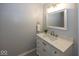 Elegant bathroom vanity with white cabinetry, marble countertop, and brushed nickel fixtures at 12845 Touchdown Dr, Fishers, IN 46037