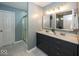 Bathroom featuring double sink vanity with blue cabinets and a walk-in shower at 12845 Touchdown Dr, Fishers, IN 46037