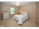 Cozy bedroom with soft carpet, white linens, and natural light from the window for a relaxing atmosphere at 12845 Touchdown Dr, Fishers, IN 46037
