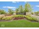 Inviting entrance to The Bristols community with manicured lawn, colorful flowers, and decorative signage at 12845 Touchdown Dr, Fishers, IN 46037