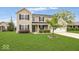 Charming two-story home featuring a well-manicured lawn, attached garage, and a welcoming front porch at 12845 Touchdown Dr, Fishers, IN 46037
