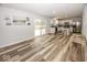 Spacious living area with wood floors, sliding door, and an open view to the kitchen at 12845 Touchdown Dr, Fishers, IN 46037