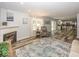 Open-concept living room with fireplace flowing into a bright kitchen at 12845 Touchdown Dr, Fishers, IN 46037