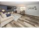 Cozy living room with a fireplace, wood floors, and ample seating at 12845 Touchdown Dr, Fishers, IN 46037