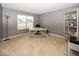 Home office features carpeted floors, neutral walls, and a large window for natural light at 12845 Touchdown Dr, Fishers, IN 46037