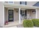 Inviting front porch with rocking chairs, decorative plants, and a wreath on the front door at 12845 Touchdown Dr, Fishers, IN 46037