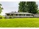 Exterior shot showcasing a well-maintained backyard, the home's rear facade and lush greenery at 130 N High School Rd, Indianapolis, IN 46214