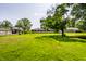 View of the spacious backyard, showcasing the lush lawn and surrounding houses at 130 N High School Rd, Indianapolis, IN 46214