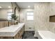 Modern bathroom featuring a double vanity, marble countertops, and elegant tile work at 130 N High School Rd, Indianapolis, IN 46214