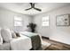 Spacious bedroom with natural light features neutral decor and a dark ceiling fan at 130 N High School Rd, Indianapolis, IN 46214