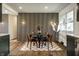 Modern dining room featuring a round table, stylish chairs, and a decorative wood slat accent wall at 130 N High School Rd, Indianapolis, IN 46214