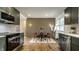 Open-concept kitchen and dining room featuring stylish cabinets and stainless steel appliances at 130 N High School Rd, Indianapolis, IN 46214