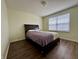 Simple bedroom with laminate flooring, a queen sized bed, and natural light at 1442 Bank Pl, Indianapolis, IN 46231