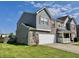 Well-maintained home with an attached two-car garage, manicured lawn, and lovely siding details on a sunny day at 1442 Bank Pl, Indianapolis, IN 46231