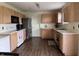 Functional kitchen with essential appliances and wooden cabinets offering ample storage space at 1442 Bank Pl, Indianapolis, IN 46231