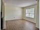 Bright living room featuring wood flooring and a window for ample natural light at 1442 Bank Pl, Indianapolis, IN 46231