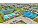 Aerial view of community amenities including a pool, tennis courts, playground, and clubhouse surrounded by homes and ponds at 1457 Birdsong Dr, Westfield, IN 46074