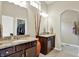 A primary bathroom features granite counters, dual sinks, modern lighting, and a walk-in closet at 1457 Birdsong Dr, Westfield, IN 46074