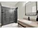 Modern bathroom featuring a glass-enclosed shower with gray tiled walls, and a stylish vanity with sleek fixtures at 1457 Birdsong Dr, Westfield, IN 46074
