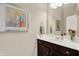 Well-lit bathroom featuring a modern vanity with a white countertop, and a framed abstract painting on the wall at 1457 Birdsong Dr, Westfield, IN 46074