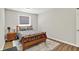 Cozy bedroom with a wooden bed frame, decorative pillows, bedside table, and a neutral-toned rug on hardwood flooring at 1457 Birdsong Dr, Westfield, IN 46074