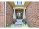 Welcoming brick front porch, decorated with colorful flower pots at 1457 Birdsong Dr, Westfield, IN 46074