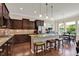 A gourmet kitchen features granite counters, stainless appliances, tile backsplash, and a center island with seating at 1457 Birdsong Dr, Westfield, IN 46074