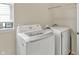 Bright laundry room with a front-loading washing machine, a dryer, and a window for natural light at 1457 Birdsong Dr, Westfield, IN 46074