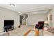 Spacious living room with a TV, comfortable seating, a staircase, and a coffee table, creating an inviting space at 1457 Birdsong Dr, Westfield, IN 46074