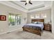 A main bedroom features neutral walls, carpet, a tray ceiling with fan, and a large window at 1457 Birdsong Dr, Westfield, IN 46074