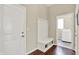 Mudroom with a built-in bench and storage, wood flooring, and an open doorway to the laundry room at 1457 Birdsong Dr, Westfield, IN 46074