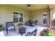 Inviting covered patio with comfortable seating and a fire pit, perfect for outdoor entertaining and relaxation at 1457 Birdsong Dr, Westfield, IN 46074