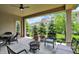 Relaxing covered patio featuring outdoor seating, a ceiling fan, and views of the landscaped backyard at 1457 Birdsong Dr, Westfield, IN 46074
